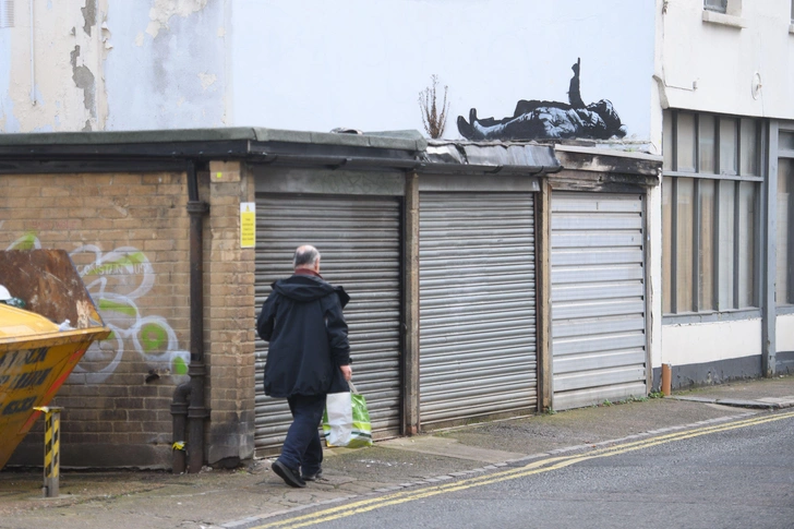 Не все счастливы в Рождество: два новых граффити Бэнкси в мокром предпраздничном Лондоне (фото)
